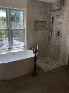 This image features a white, stand alone tub.