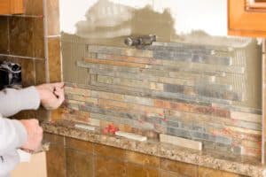 Close-up of a tile backsplash installation—learn how much to install backsplash depending on tile type and labor costs