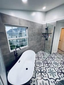 This image features a bathroom with grey designed tile.