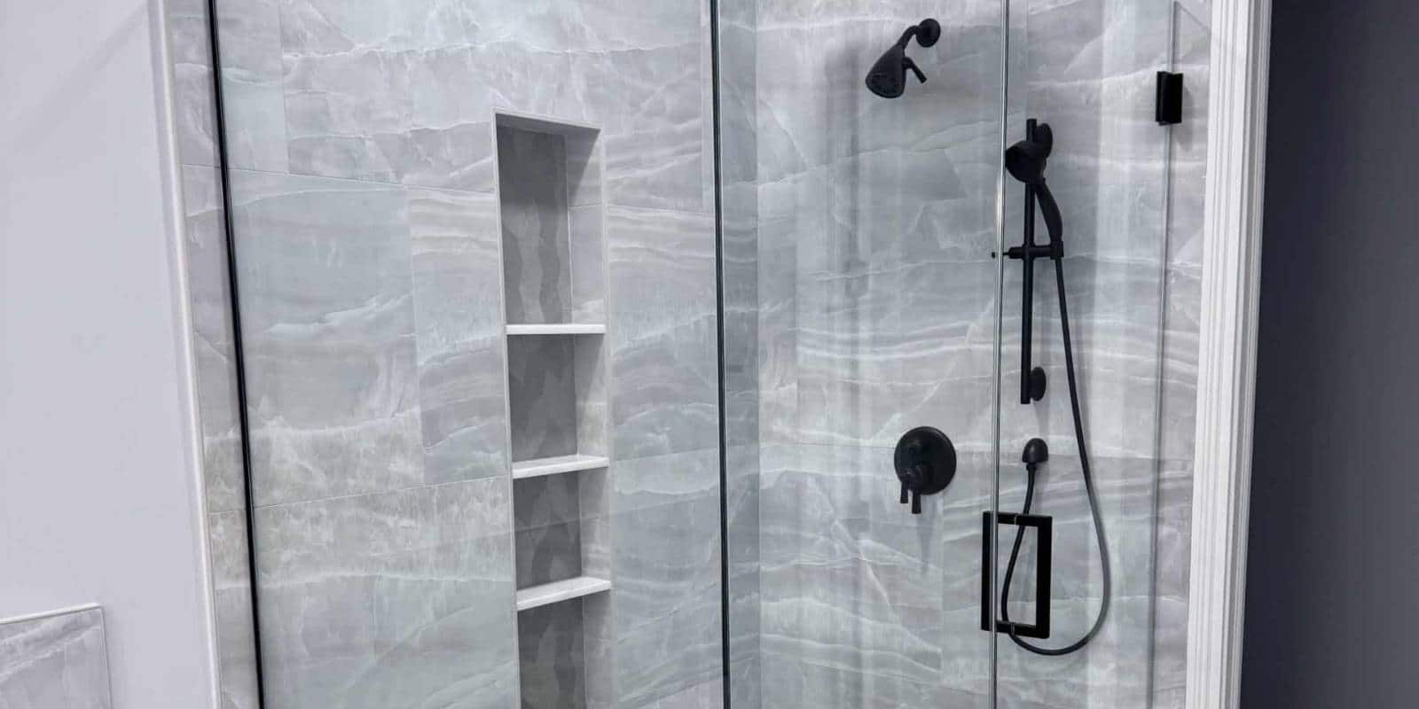 Shower Remodel Trends with frameless glass shower and marble-look tile