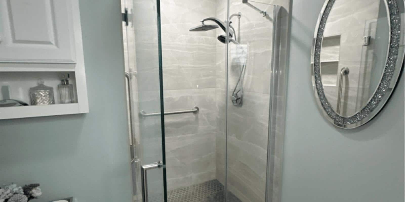 Luxury spa-style bathroom shower with rainfall showerhead and stone pebble flooring